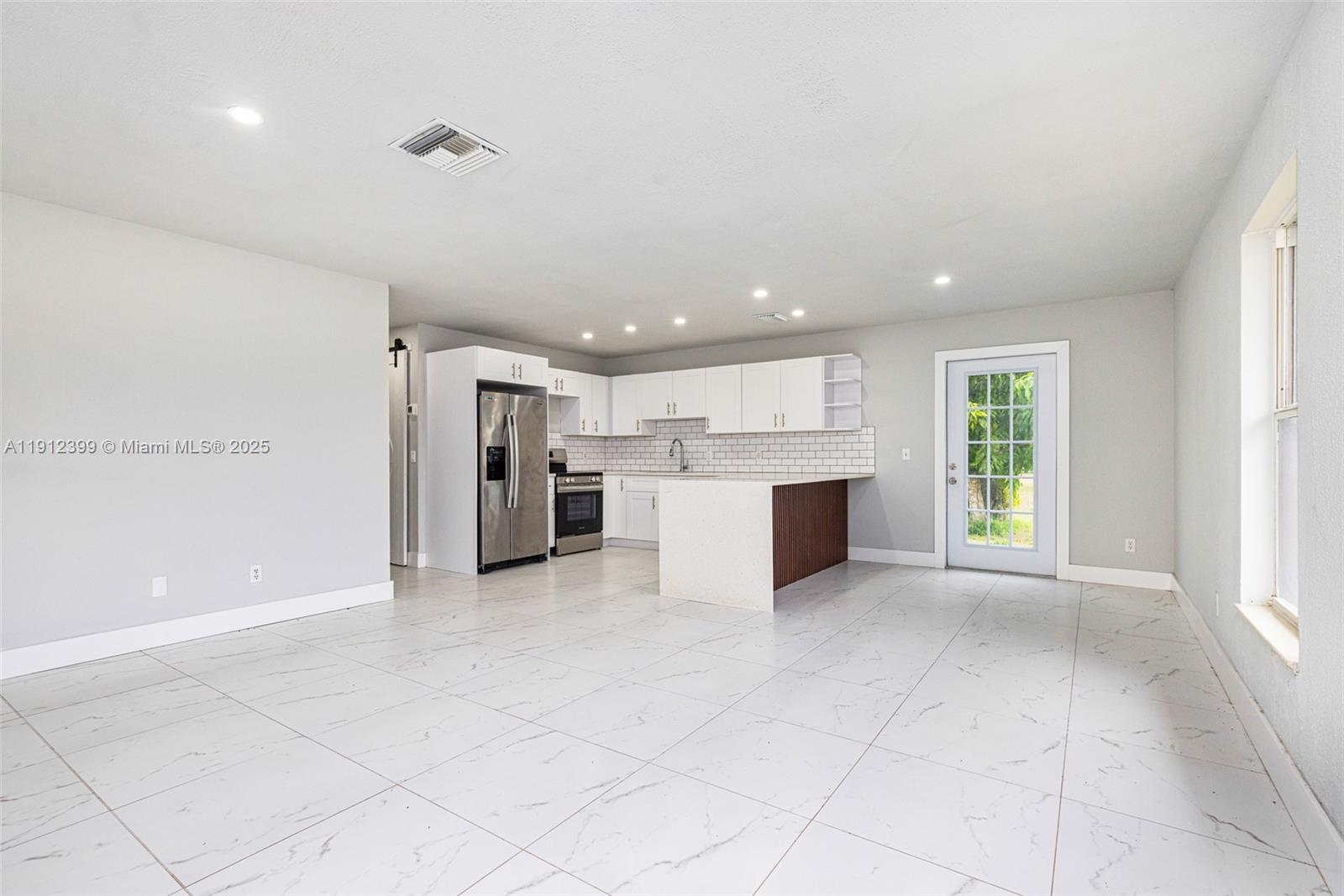 2404 Silver Lake Road LaBelle, FL 33935 - Photo 60 of 89 a view of a kitchen with a sink and an empty room