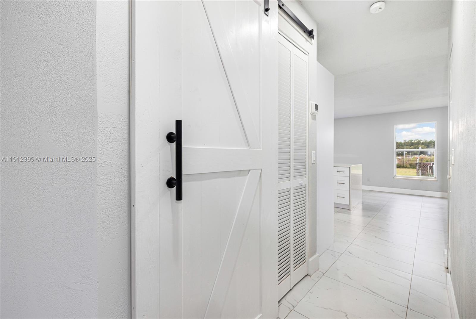 2404 Silver Lake Road LaBelle, FL 33935 - Photo 66 of 89 a view of a hallway with wooden floor and staircase