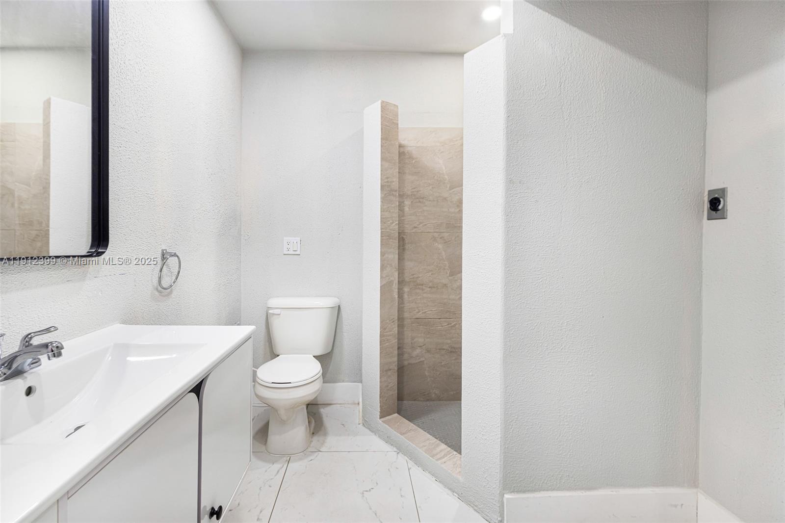 2404 Silver Lake Road LaBelle, FL 33935 - Photo 67 of 89 a bathroom with a toilet sink and a mirror