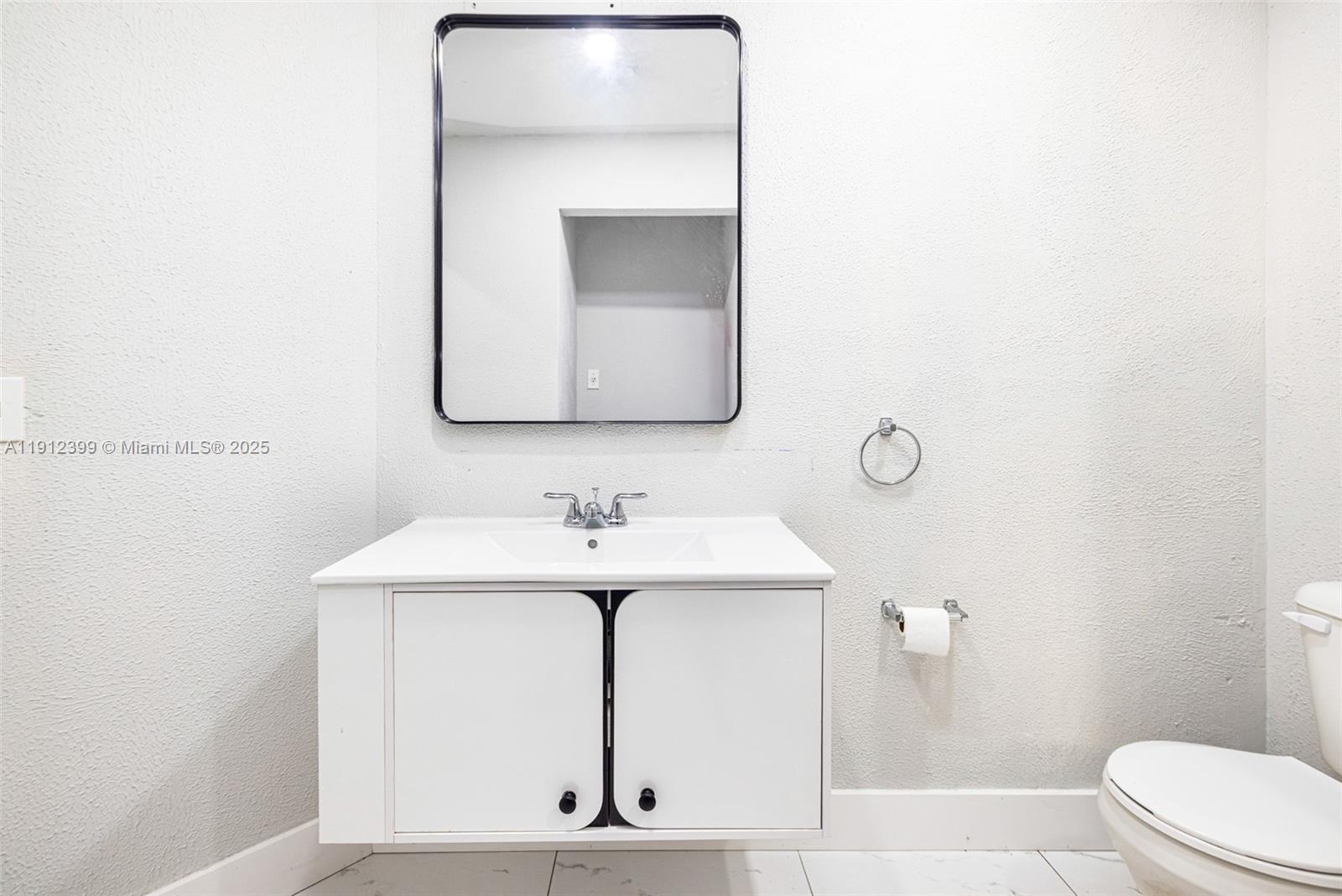 2404 Silver Lake Road LaBelle, FL 33935 - Photo 68 of 89 a bathroom with a toilet sink and mirror