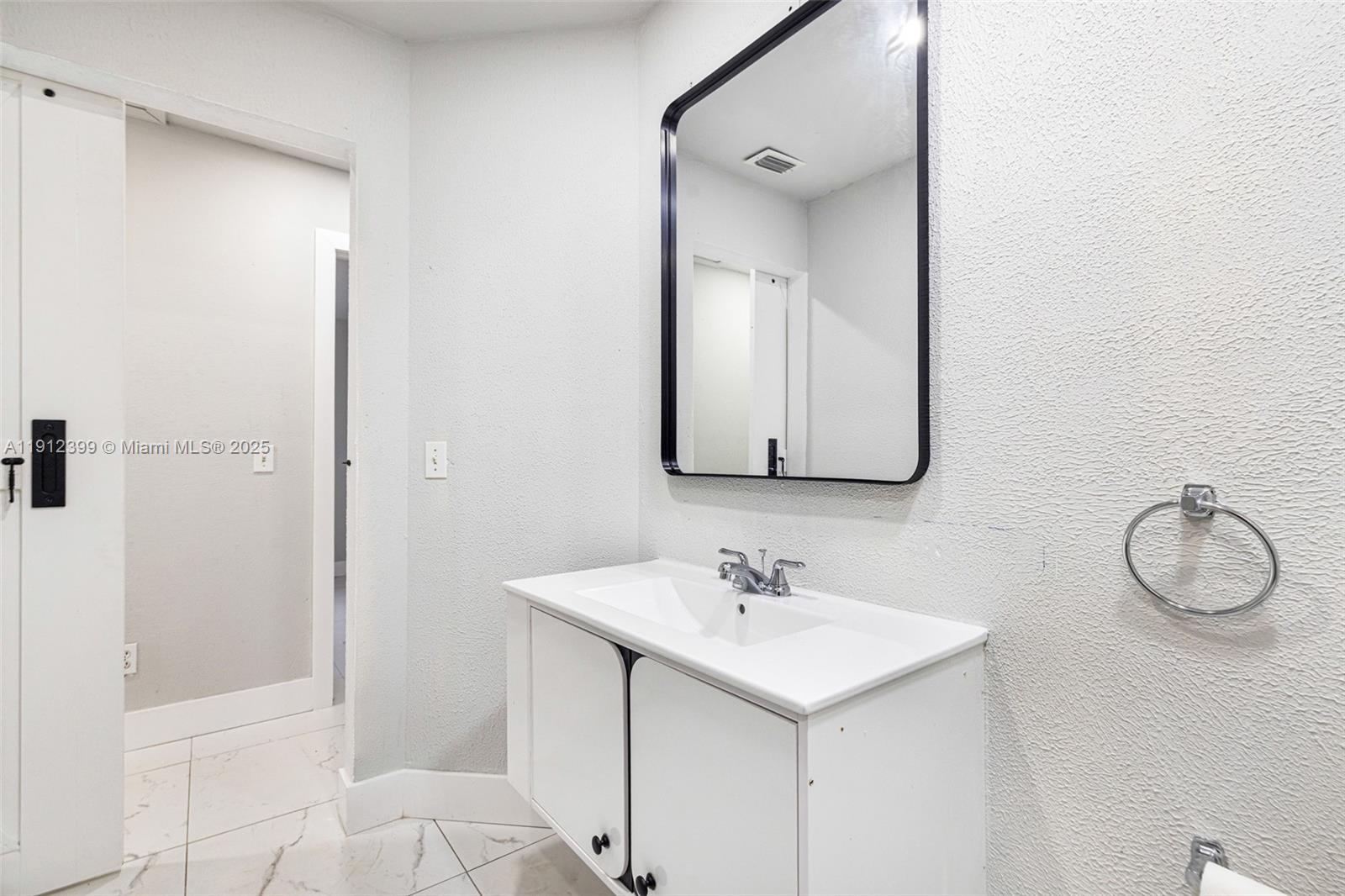2404 Silver Lake Road LaBelle, FL 33935 - Photo 69 of 89 a bathroom with a sink vanity and a mirror