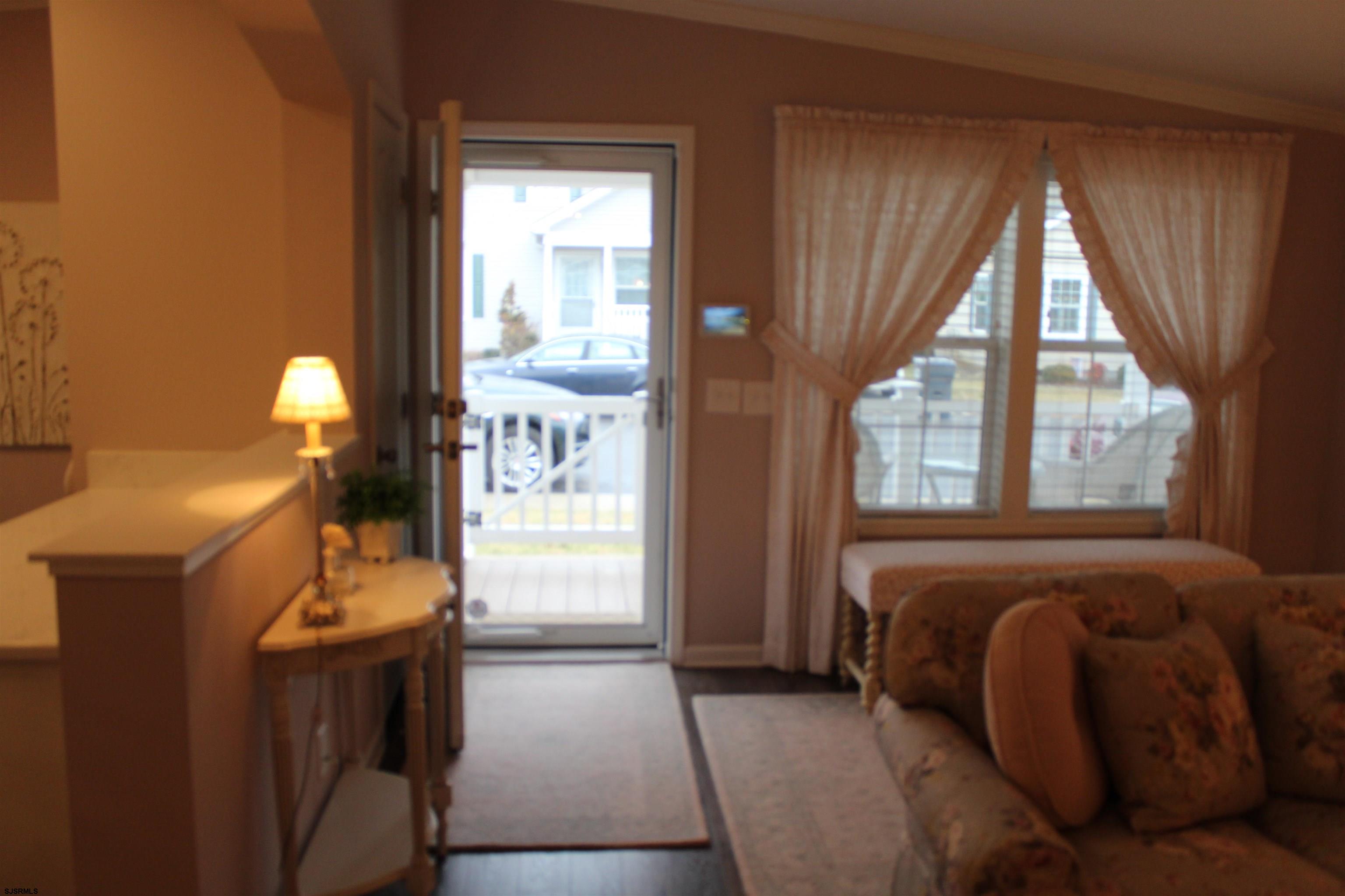 2058 South Shore Road, Unit 210 Ocean View, NJ 08230 - Photo 12 of 17 a bedroom with a bed and large windows