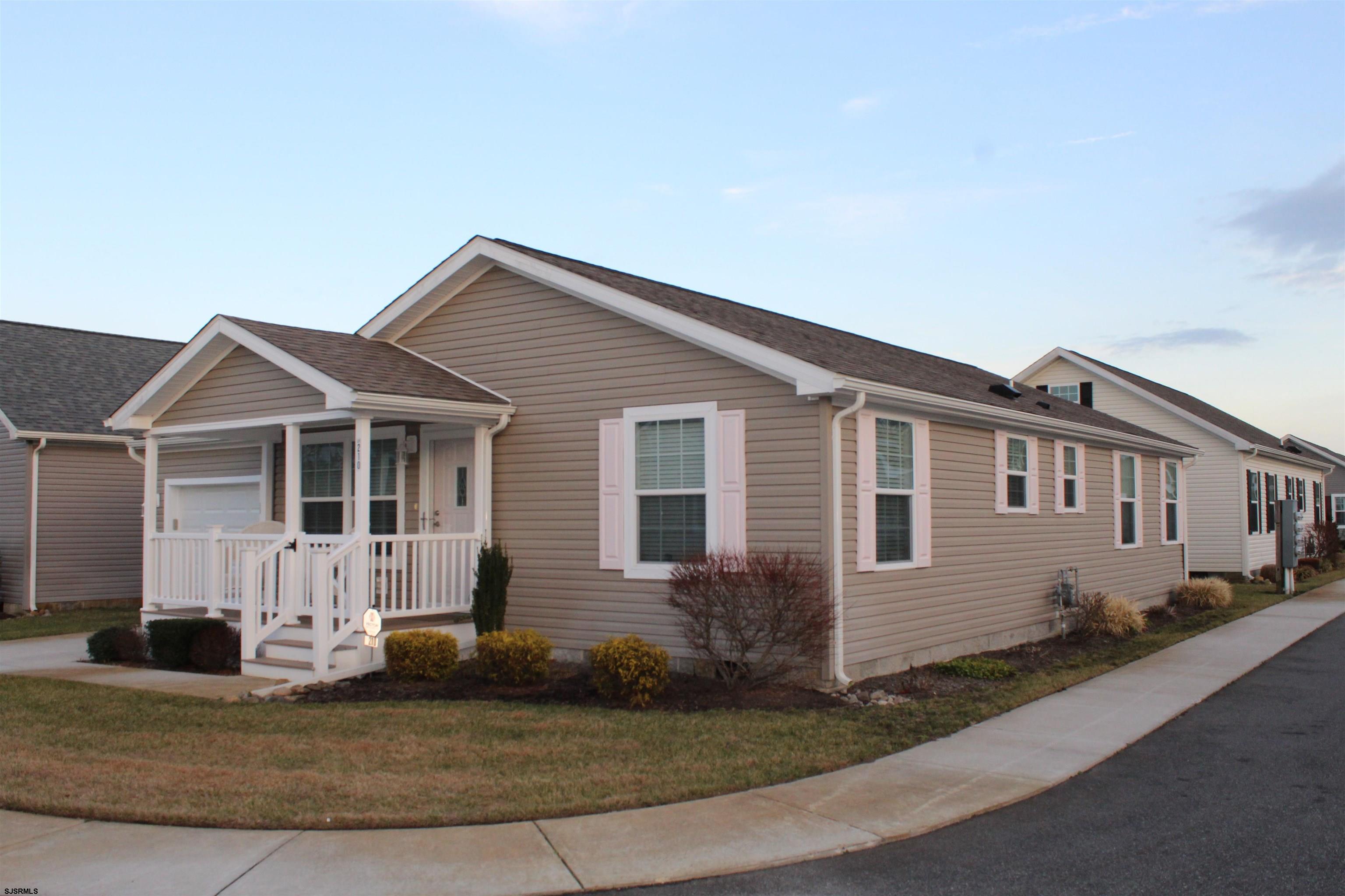 2058 South Shore Road, Unit 210 Ocean View, NJ 08230 - Photo 16 of 17 a front view of a house with a yard