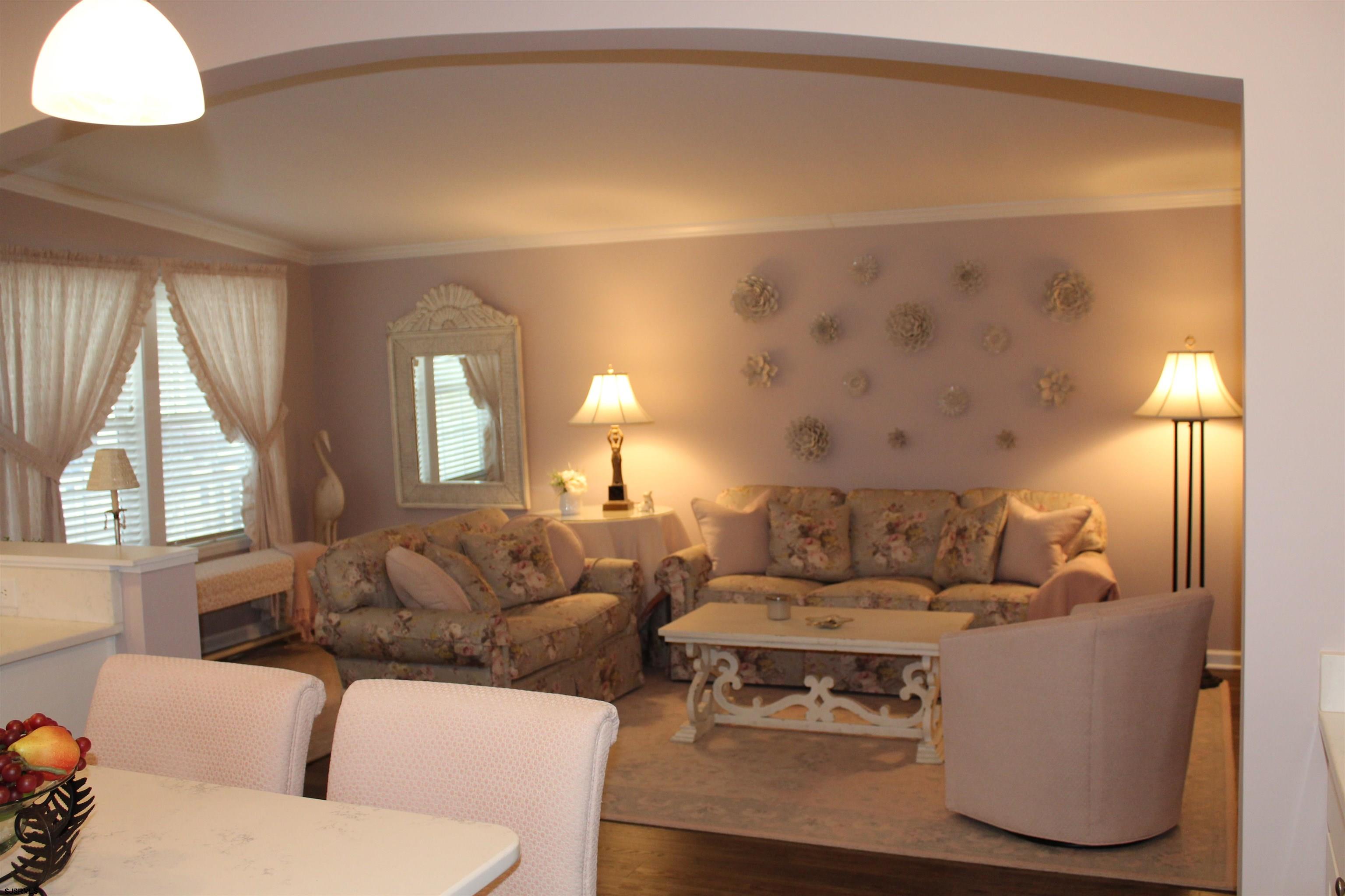 2058 South Shore Road, Unit 210 Ocean View, NJ 08230 - Photo 3 of 17 a living room with furniture and a large window