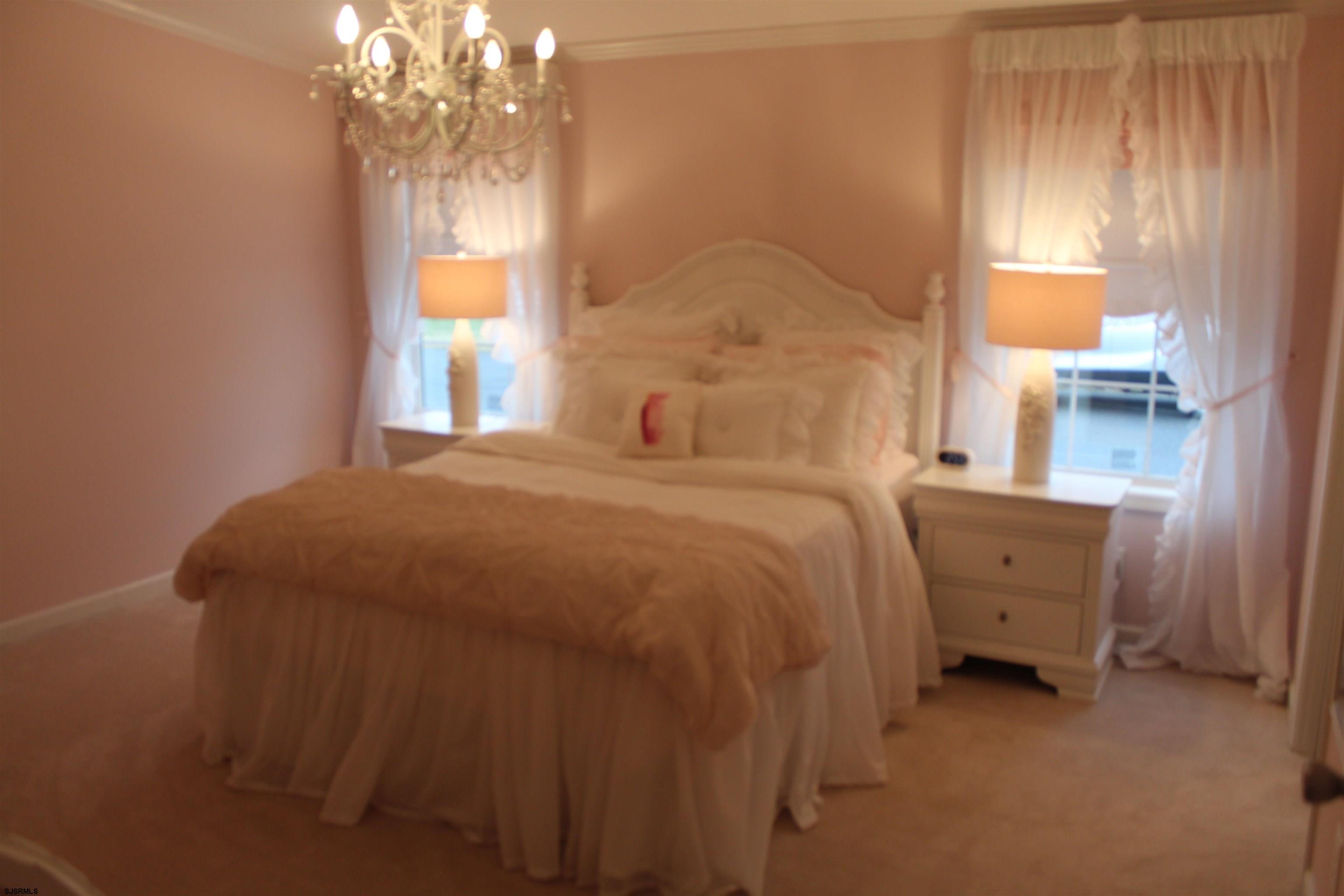 2058 South Shore Road, Unit 210 Ocean View, NJ 08230 - Photo 8 of 17 a bedroom with a bed and a window