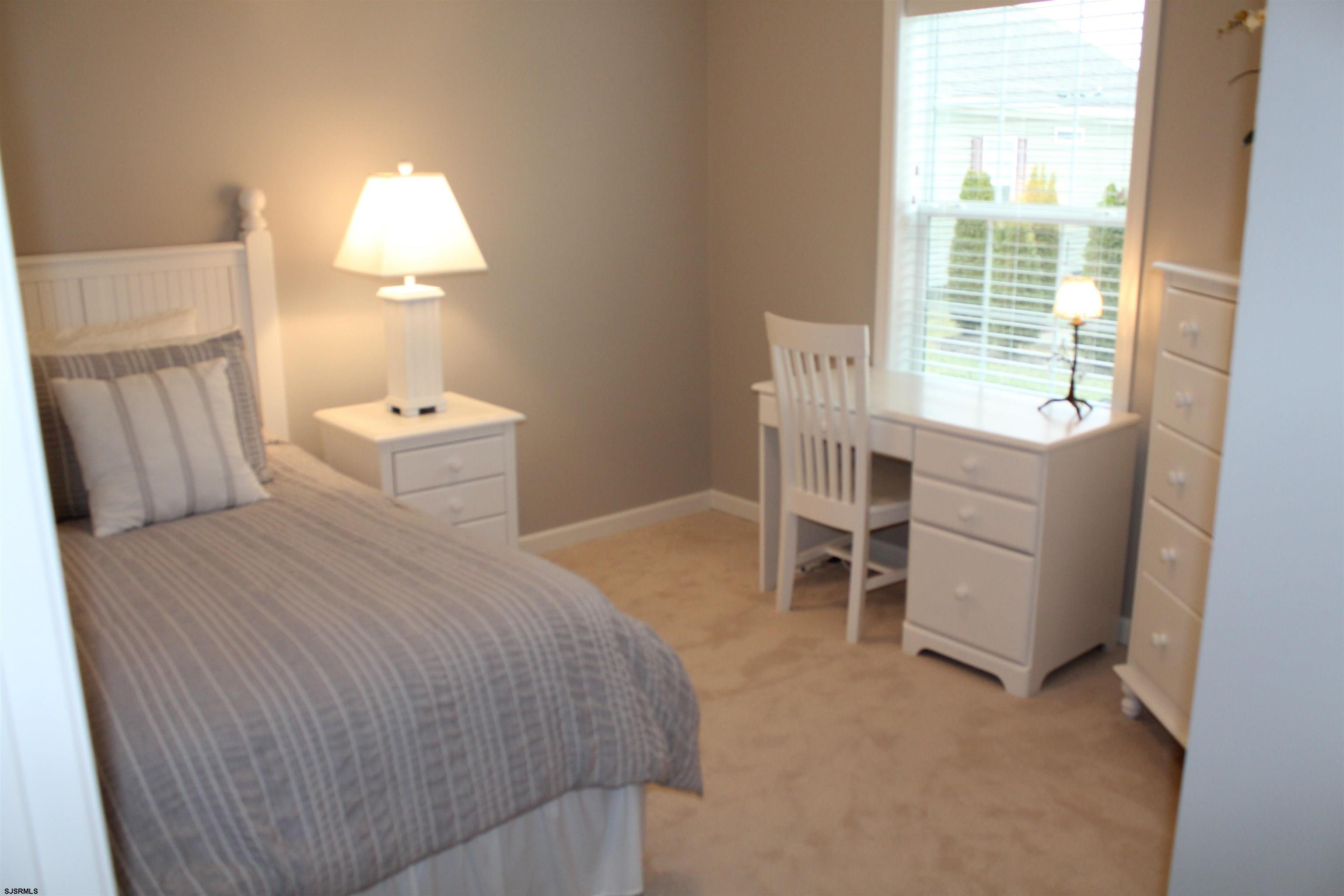 2058 South Shore Road, Unit 210 Ocean View, NJ 08230 - Photo 10 of 17 a bedroom with a bed and a window