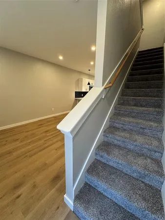 a view of entryway and hall with wooden floor