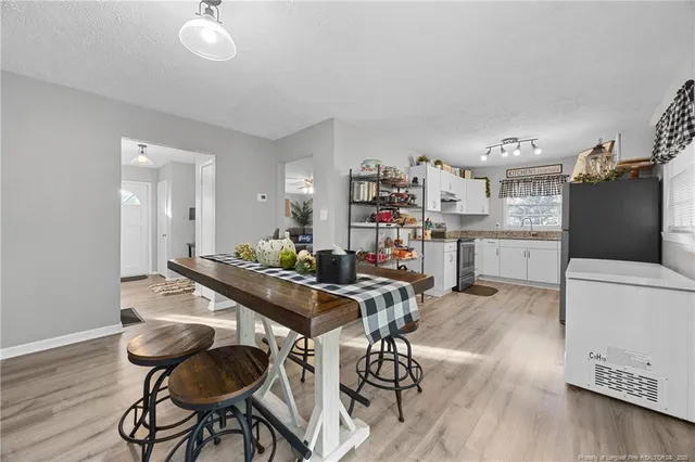 a view of a workspace with furniture and wooden floor