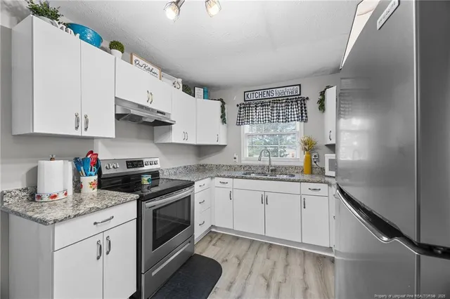 a kitchen with appliances cabinets and a sink