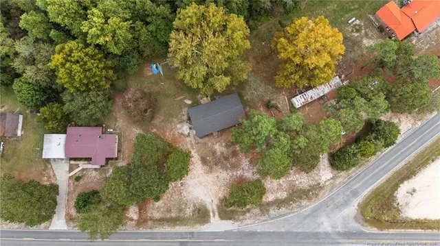 an aerial view of a house with a yard basket ball court and outdoor seating
