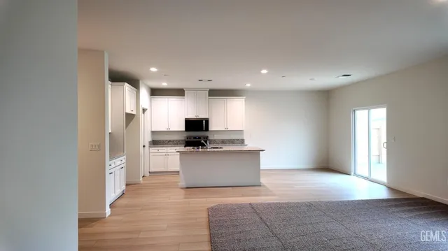 a kitchen with a refrigerator and a stove top oven