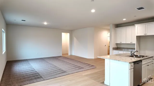 a view of kitchen with granite countertop cabinets and wooden floor