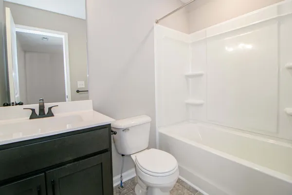 a bathroom with a sink a toilet and a bathtub