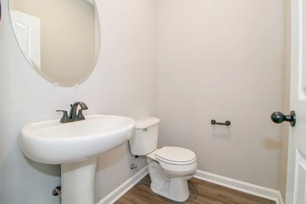 a white toilet sitting next to a bathroom sink