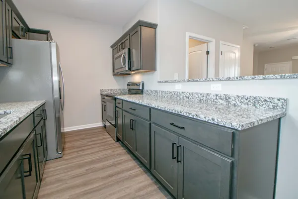 a kitchen with a sink stove and refrigerator
