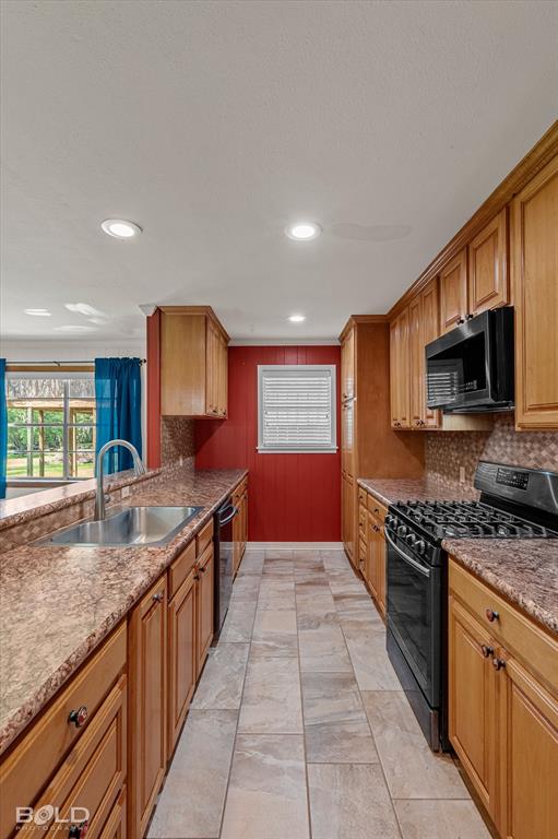 225 Marie Road Ringgold, LA 71068 - Photo 29 of 40 Galley kitchen featuring wood cabinetry, stone-look countertops, and tile flooring