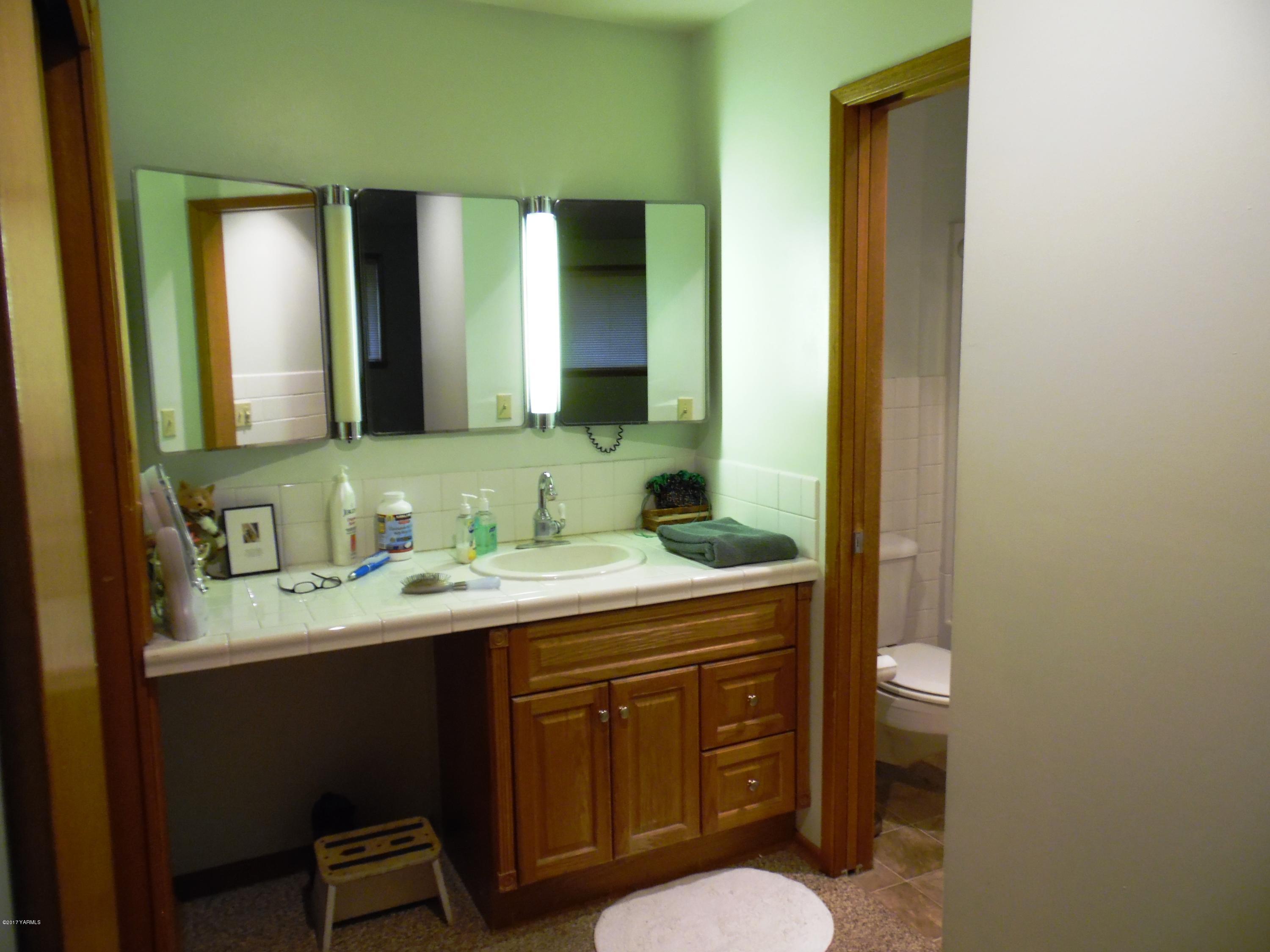 220 Rosenkranz Road Tieton, WA 98947 - Photo 13 of 48 a bathroom with a granite countertop sink toilet and mirror