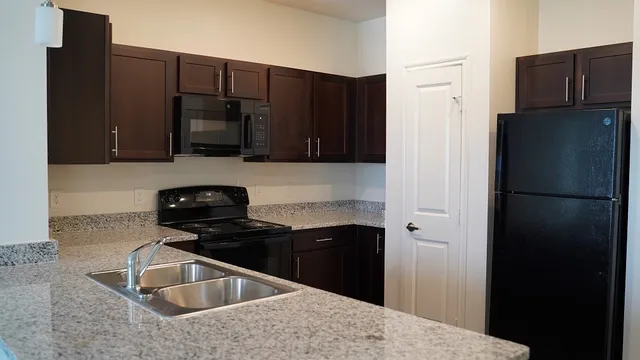 a kitchen with a sink a stove and refrigerator