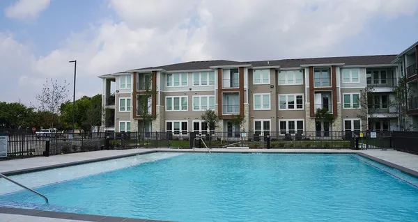 a front view of a house with swimming pool and patio