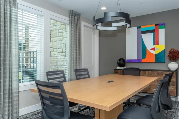 a view of a dining room with furniture and chandelier