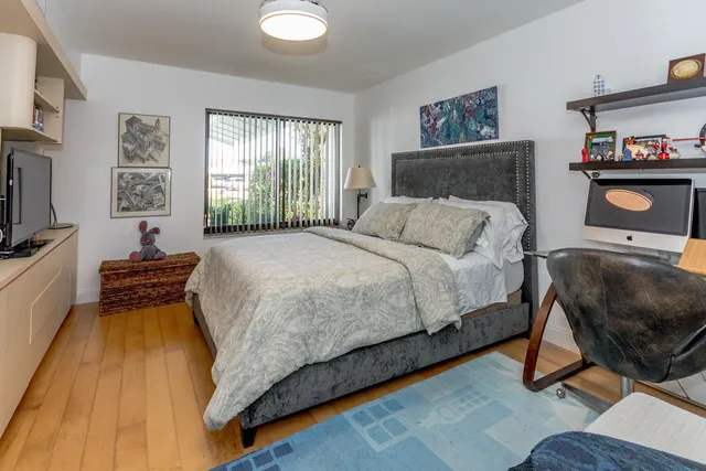 a bed room with a bed and a chair