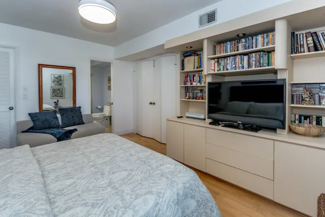 a bedroom with furniture and a flat screen tv