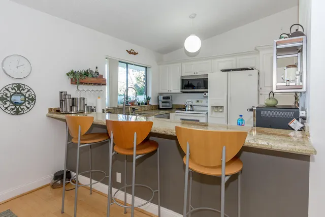 a dining room with furniture a window and a kitchen view