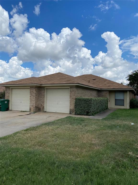 a view of a house with a yard and garage