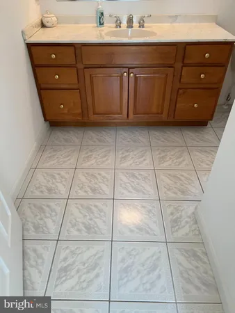 a spacious bathroom with a sink vanity and mirror