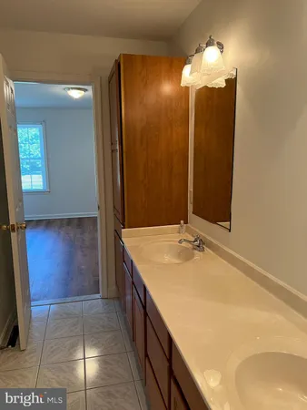 a bathroom with a sink a vanity and a mirror