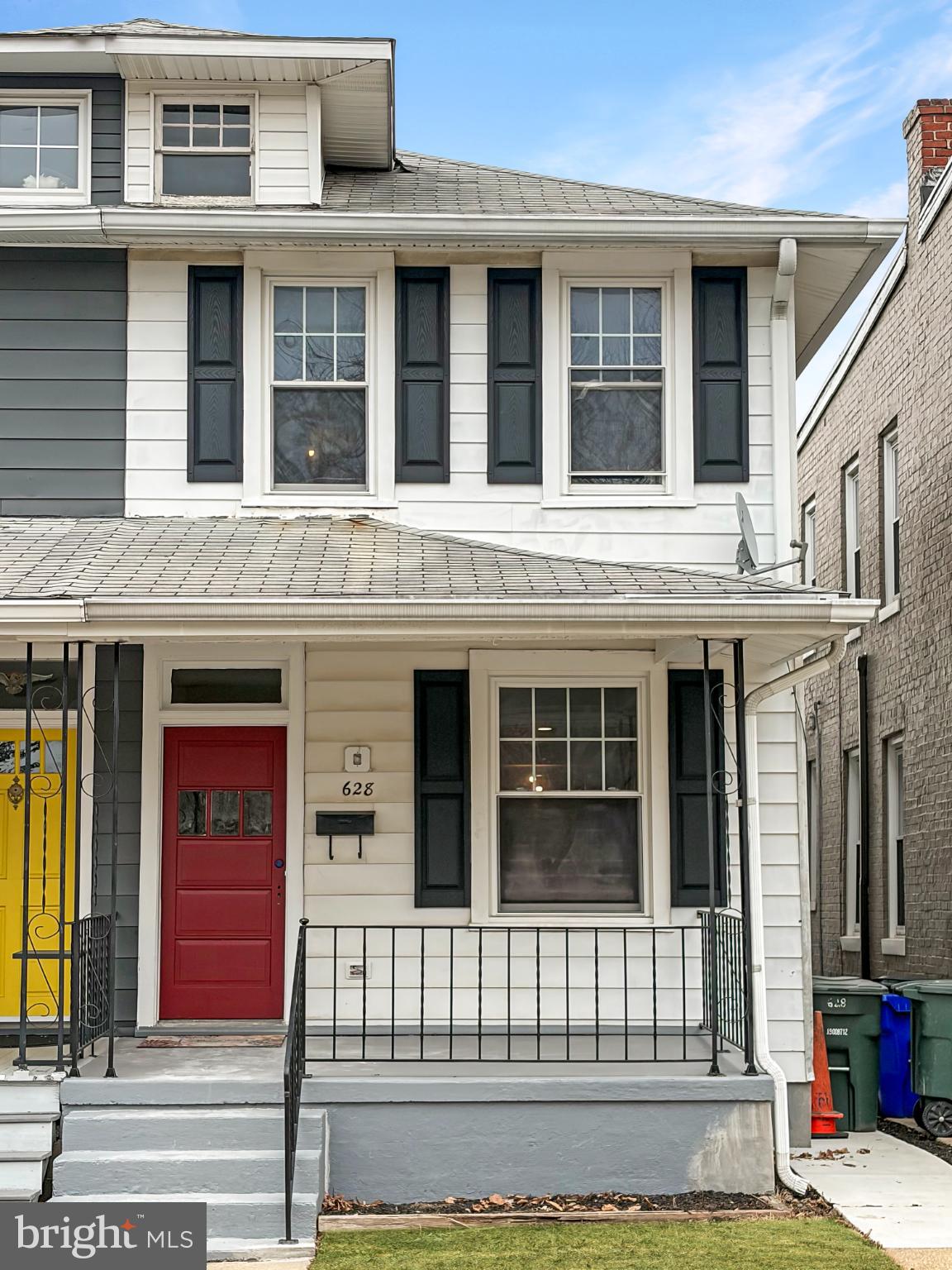 Charming duplex with vibrant red door.