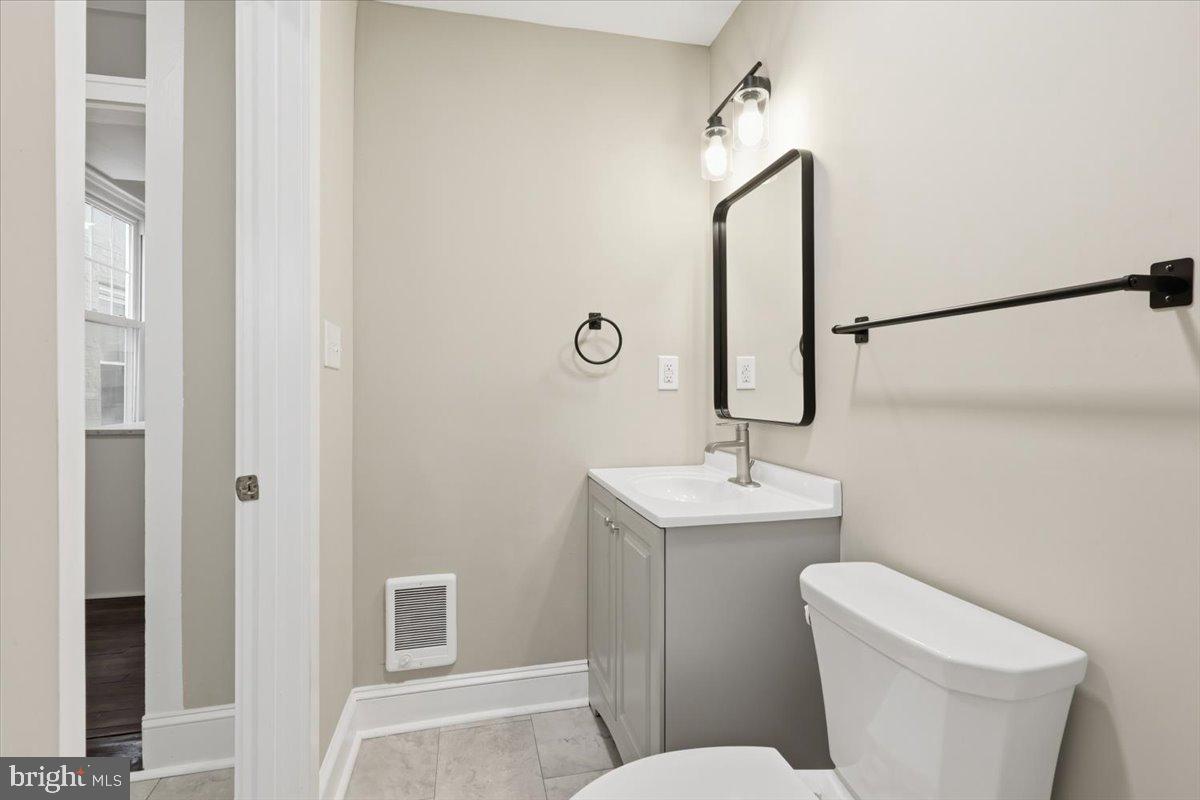 628 Trail Avenue Frederick, MD 21701 - Photo 11 of 37 a bathroom with a toilet sink and mirror