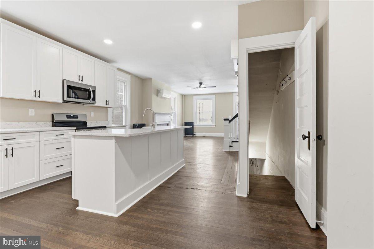 628 Trail Avenue Frederick, MD 21701 - Photo 13 of 37 a kitchen with white cabinets and stainless steel appliances