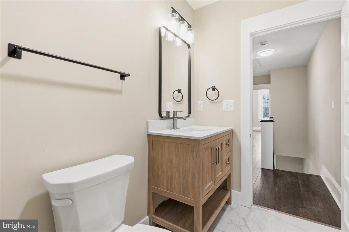 628 Trail Avenue Frederick, MD 21701 - Photo 18 of 37 a bathroom with a sink a toilet and a mirror