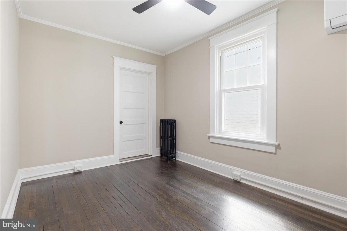 628 Trail Avenue Frederick, MD 21701 - Photo 19 of 37 an empty room with wooden floor and windows