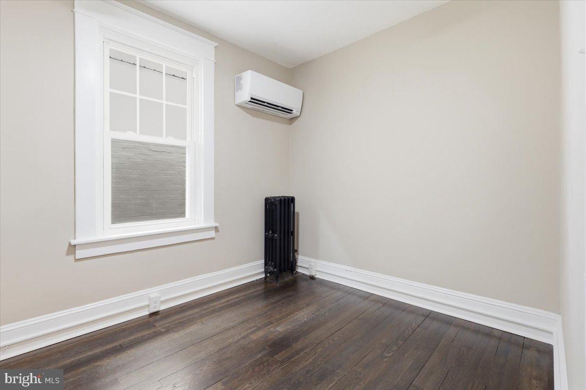628 Trail Avenue Frederick, MD 21701 - Photo 23 of 37 an empty room with wooden floor and windows