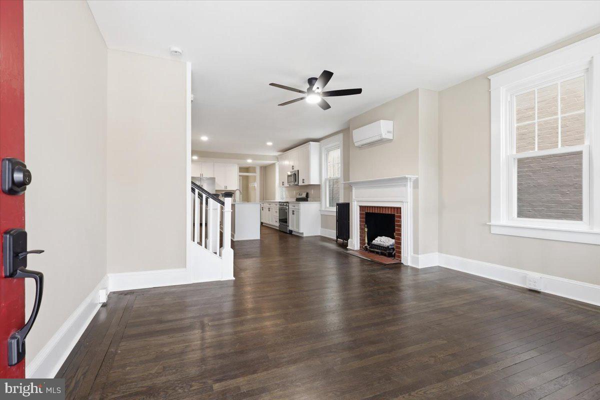 628 Trail Avenue Frederick, MD 21701 - Photo 5 of 37 a view of empty room with wooden floor and fireplace