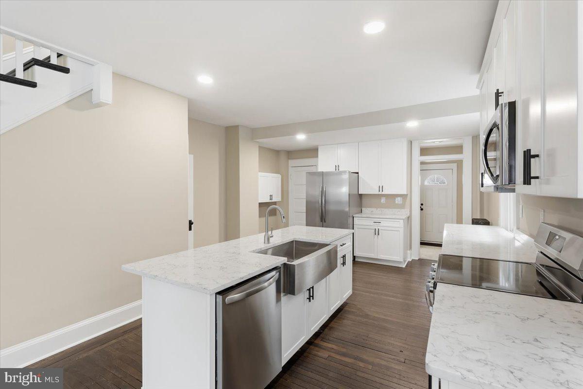 628 Trail Avenue Frederick, MD 21701 - Photo 8 of 37 a large white kitchen with stainless steel appliances