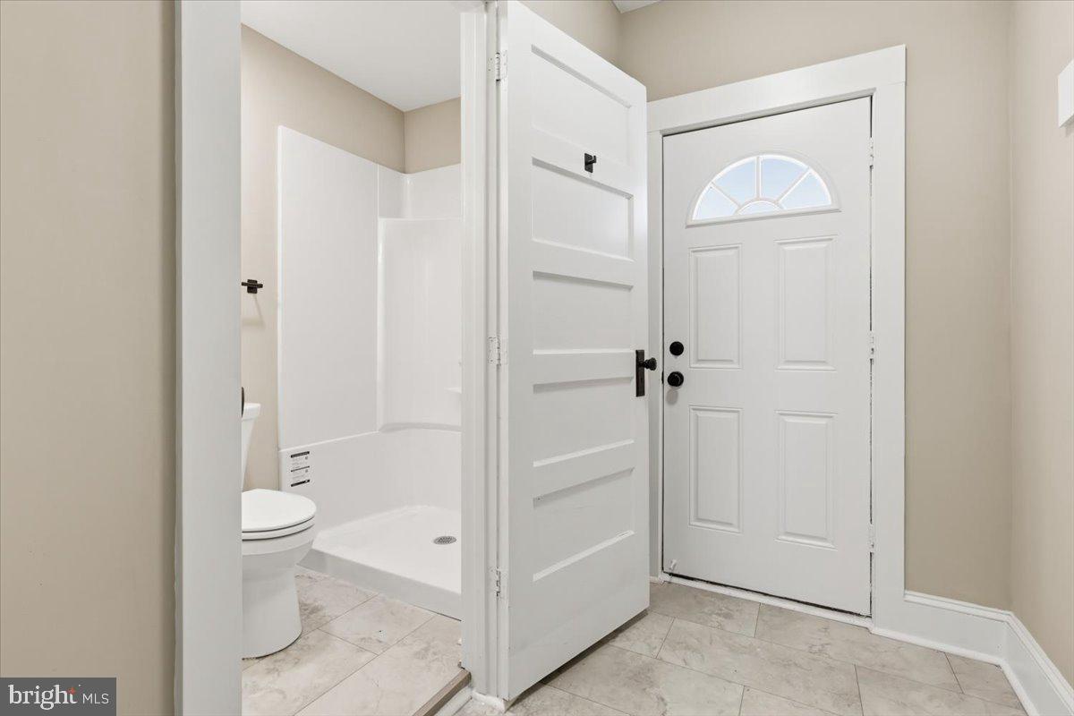 628 Trail Avenue Frederick, MD 21701 - Photo 10 of 37 a bathroom with a granite countertop sink a toilet and a shower