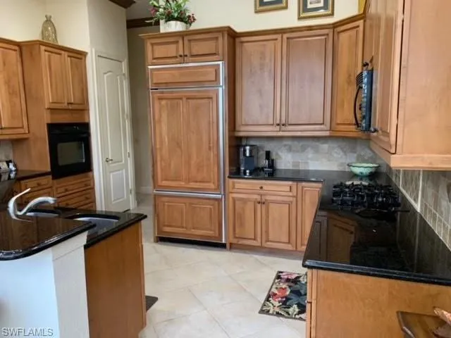 a kitchen with a refrigerator stove and white cabinets