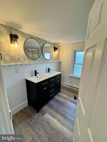 a bathroom with a double vanity sink and a mirror