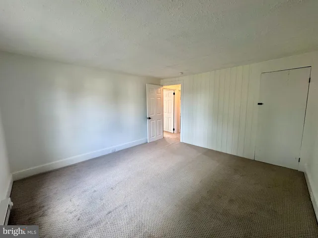 a view of an empty room and entryway