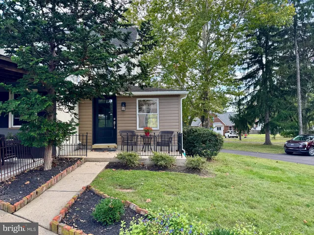 a view of a house with backyard and a tree