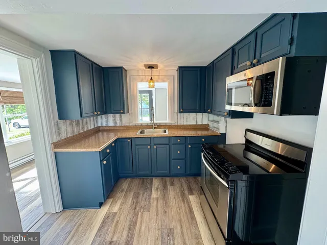 a kitchen with granite countertop a stove and a sink
