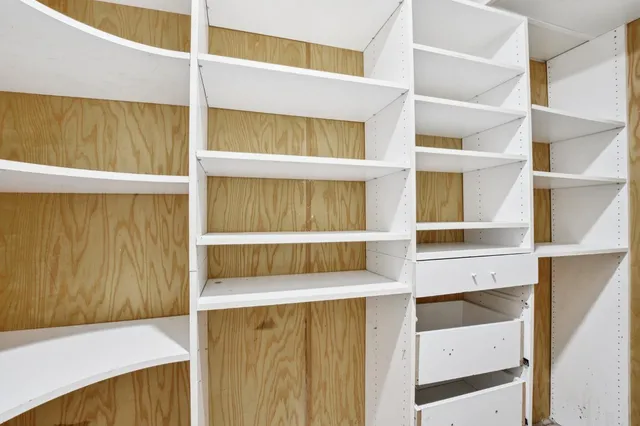a view of a room with wooden floor and white walls