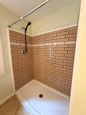 a bedroom with a bed and a potted plant