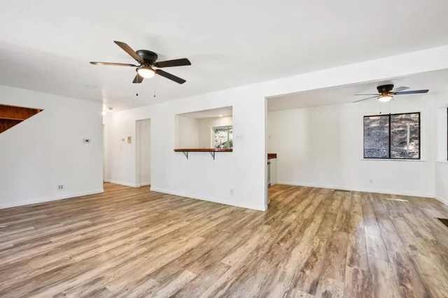 a view of a chairs and table in the backyard