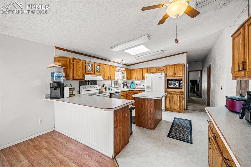 8435 Savage Road Beulah, CO 81023 - Photo 12 of 34 a kitchen with counter top space and view of living room