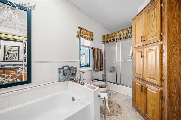 a bathroom with a bathtub a toilet and a shower