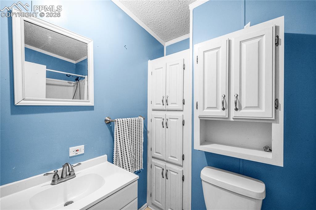 8435 Savage Road Beulah, CO 81023 - Photo 22 of 34 a bathroom with a sink a toilet and shower